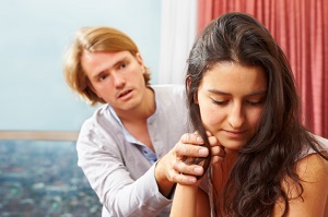 Worried man trying to talk to sad woman